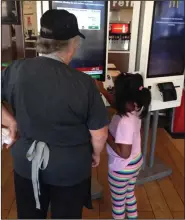  ?? Caitlan Butler/News-Times ?? So easy: Ragen Vanhook, 6, orders a Happy Meal with the help of McDonalds employee Violette VinZant.