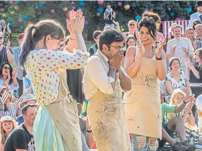  ?? PA. ?? Finalists Kim-Joy and Ruby celebrate with winner Rahul as he is given the cake-stand trophy.