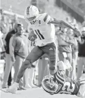  ?? ?? Miami wide receiver Charleston Rambo gets hit by Duke safety Jalen Alexander as he runs upfield during the second half Saturday in Durham, N.C.