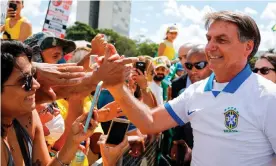  ??  ?? Jair Bolsonaro greets supporters in Brasilia. Photograph: Sergio Lima/AFP via Getty
