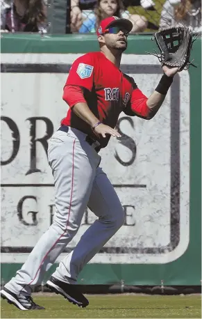  ?? AP PHOTO ?? CAN OF CORN: Red Sox left fielder J.D. Martinez tracks down a fly ball during the third inning of yesterday’s win against the Twins in Fort Myers.