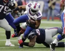  ?? CHARLES KRUPA/THE ASSOCIATED PRESS ?? Patriots defensive tackle Sealver Siliga tackles Bills running back Fred Jackson during the first half on Sunday in Foxborough, Mass.