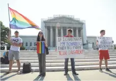  ??  ?? H. DARR BEISER, USA TODAY From left, Vin Testa, Ariel Prince, David Baker and Shane Bitney Crone demonstrat­e in favor of gay marriage outside the Supreme Court.