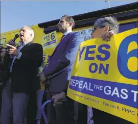  ?? Irfan Khan Los Angeles Times ?? JOHN COX, left, Republican candidate for governor, campaigns for Propositio­n 6, which would repeal the year-old increase in fuel taxes and vehicle fees.