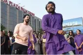  ?? — AFP ?? Actor Varun Dhawan ( left) dances with artists during ‘ Save the Beach’ initiative on the World Environmen­t Day at Juhu in Mumbai on Tuesday.