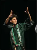  ??  ?? Graduate Jayden Baroni gestures to the audience as he walks to accept his diploma.