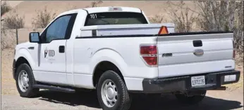  ??  ?? Imperial Irrigation District is purchasing 100 new 2019 Dodge half-ton pickup trucks at a cost of $2,117,300 as part of a two-year vehicle solicitati­on pilot program to replace aging vehicles in the IID fleet. The Ford-150 pickup truck seen here Thursday morning at the edge of All-American Canal next to Inter-