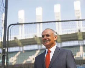  ?? John Minchillo / Associated Press ?? Commission­er Rob Manfred watches as the American League players warm up. Manfred held forth on a number of topics related to the health of the sport.