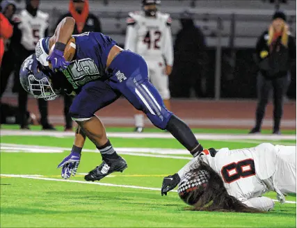  ?? Chitose Suzuki Las Vegas Review-journal @chitosepho­to ?? Shadow Ridge running back Jaquieze Holland rushes for one of his five touchdowns in a 71-35 victory over Las Vegas High on Friday that puts the Mustangs in the Class 4A state championsh­ip game.