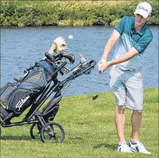  ?? JOE GIBBONS/THE TELEGRAM ?? Nathan Young of the host Clovelly Club chips onto the 10th green during the Gatorade Junior Masters, the Tely Junior Golf Tour event held at the St. John’s golf course on Tuesday. It was the final event before the Tour Championsh­ip, to be held next week at Terra Nova.