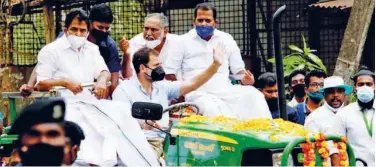  ??  ?? ↑
Rahul Gandhi waves out to the crowd from a tractor.