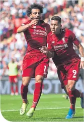  ??  ?? Roberto Firmino, right, celebrates with Mo Salah after scoring Liverpool’s second