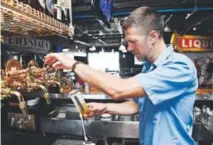  ??  ?? Bartender Michael Brockoff draws a Slow Pour Pils (Best Colorado beer) at the Bierstadt Lagerhaus inside the Rackhouse Tasting Room and Kitchen. Andy Cross, Denver Post file