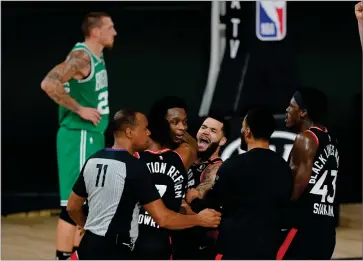  ?? AP PHOTO BY MARK J. TERRILL ?? Teammates mob Toronto Raptors’ OG Anunoby, second player from left, after Anunoby’s game winning shot at the buzzer in the second half of an NBA conference semifinal playoff basketball game against the Boston Celtics Thursday, Sept 3, in Lake Buena Vista Fla. Celtic’s Daniel Theis is at rear.