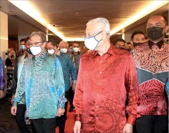  ?? ?? (From left) Abang Johari and Ismail Sabri arrive at the BCCk for the launch of the ‘keluarga Malaysia’ concept. — Photo by Roystein Emmor