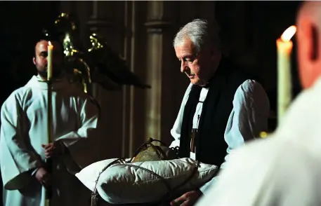  ??  ?? Archbishop Michael Jackson with the relic in Christ Church Cathedral last night. Photo: Reuters