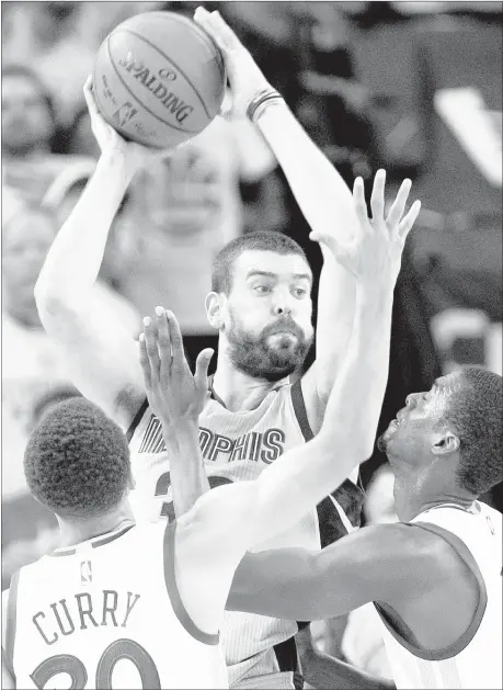  ?? NIKKI BOERTMAN / THE COMMERCIAL APPEAL FILES ?? Grizzlies center Marc Gasol has a special connection with Memphis after attending high school at Lausanne and returning as Pau’s overlooked kid brother who helped make the Grizzlies a perennial playoff team. Above, Gasol looks for help while defended...