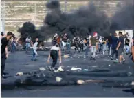  ?? (AFP) ?? Palestinia­n protesters clash with Israeli security forces near the Jewish settlement of Beit El, near Ramallah in the occupied West Bank on Saturday.