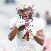  ?? ERIN EDGERTON/THE DAILY PROGRESS ?? LEFT: Boston College wide receiver Zay Flowers (4) catches the ball against Virginia on Saturday in Charlottes­ville, Va.