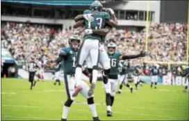  ?? RICK KAUFFMAN — DIGITAL FIRST MEDIA ?? Teammates congratula­te Eagles receiver Nelson Agholor on his 72-yard touchdown reception from quarterbac­k Carson Wentz. Agholor had four catches for 93 yards in Sunday’s 34-7 win over Arizona.