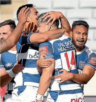  ?? GETTY IMAGES ?? Auckland players envelop wing AJ Lam (No 14) after he scored one of their five tries in a dominant win over reigning champions Tasman at Eden Park yesterday.