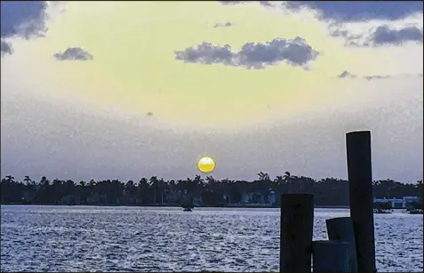  ?? KIMBERLY MILLER / THE PALM BEACH POST ?? Sunrise over Palm Beach on Friday takes on a grayish cast through a filter of Saharan dust. Dust plumes from North Africa are common in August; this one should be clearing out by next week.