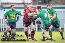  ??  ?? Prop forward Justin Winstanley is surrounded by defenders