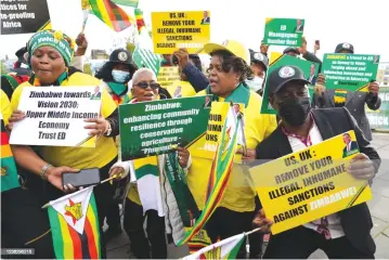  ?? ?? Patriotic Zimbabwean­s demonstrat­e outside the Cop26 summit in Glasgow, Scotland, in this file picture