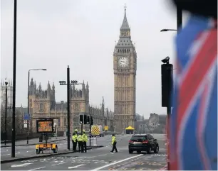  ?? PICTURE: AP ?? Police work on Westminste­r Bridge yesterday at the scene of the terror attack on the Houses of Parliament in London.