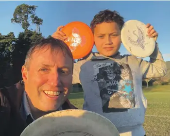  ?? ?? Big Brothers Big Sisters of Nelson-Tasman mentor Martin De Ruyter playing disc golf with his young friend Messiah, 10, at Isel Park.