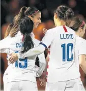  ?? IAN MACNICOL/GETTY ?? American Alex Morgan, center, is congratula­ted by teammates after she scored against Scotland on Tuesday at The Simple Digital Arena.