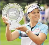  ?? CORY OLSEN / THE GRAND RAPIDS PRESS ?? Brooke Henderson dedicated her victory Sunday in the Meijer LPGA Classic to her father and coach, Dave.
