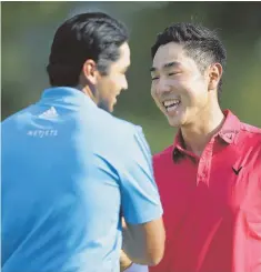 ?? AP PHOTO ?? FRIENDLY RIVALS: Bae Sang-moon, right, and Jason Day shake hands after finishing the 18th hole in the third round of The Barclays yesterday in Edison, N.J.