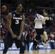  ?? BEN MARGOT — THE ASSOCIATED PRESS ?? Xavier players including Sean O’Mara, right, and Quentin Goodin (3) celebrate after beating Arizona during an NCAA Tournament college basketball regional semifinal game Thursday in San Jose.