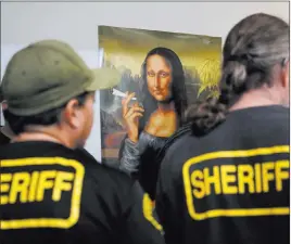  ?? Jae C. Hong ?? The Associated Press Undercover Los Angeles County sheriff ’s deputies gather March 15 inside an illegal marijuana dispensary during a raid in Compton, Calif. California ushered in broad marijuana legalizati­on nearly six months ago, but the illegal...