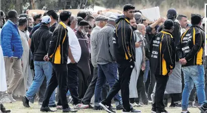  ?? PHOTOS: REUTERS & AP ?? Laid to rest . . . The bodies of father and son Khaled and Hamza Mustafa are carried for their burial ceremony at the Memorial Park Cemetery in Christchur­ch, yesterday. Right: Zaid Mustafa, brother of Hamza and son of Khalid Mustafa attended their funerals.