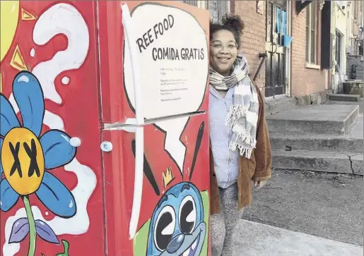  ?? Paul Grondahl / Special to the Times Union ?? Eight colorful free food refrigerat­ors have been placed in urban locations in Albany, Schenectad­y and Troy. Jammella Anderson shows off the first one, located next to The Free School at 8 Elm St. in Albany and painted by the artist known as Trash Kid Art.