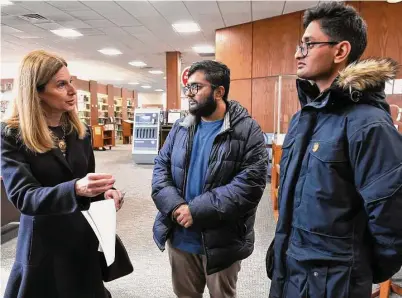  ?? Ned Gerard/Hearst Connecticu­t Media ?? Lt. Gov. Susan Bysiewicz speaks with brothers Akshat, center, and Bharat Misra prior to a news conference at the Norwalk Public Library in Norwalk on Thursday. The Misra brothers’ mother, Divya, was shot and killed by her husband in a murder-suicide in May of 2021. Divya Misra worked as a librarian at the library.