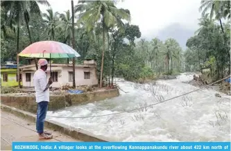  ?? — AFP ?? KOZHIKODE, India: A villager looks at the overflowin­g Kannappana­kundu river about 422 km north of Trivandrum in the south Indian state of Kerala yesterday.