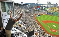  ?? Matt Freed/Post-Gazette ?? Pirates broadcaste­r Steve Blass showers the fans with hats during his final seventh-inning stretch in the radio booth Sept. 29 at PNC Park.