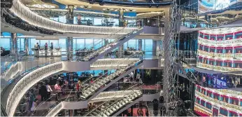  ?? AARON SAUNDERS ?? The MSC Seaside’s glass-walled atrium stretches over multiple decks, creating a venue for live entertainm­ent with stunning ocean views.