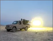  ?? AP ?? This picture released July 12 by the Rased News Network shows an Islamic State fighter firing a truck-mounted weapon at Syrian forces in Homs province.