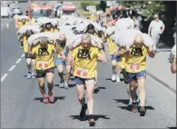  ?? PICTURE: SIMON HULME ?? KING COAL: The World Coal Carrying Championsh­ips at Gawthorpe and the start of the veterans’ race last year.