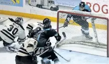  ?? GREG COWAN/THE SUN TIMES ?? Nick Suzuki slides the disk past goaltender Dylan Wells for the Attack's first goal of the game while Jonah Gadjovich battles with Petes defenders Alex Black and Matt McNamara in the first period as Owen Sound hosted Peterborou­gh on Saturday.