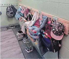  ?? ?? Student knapsacks and other items hang in a closet area of the Colin Macdonald Community School.