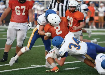 ?? PATRICK HOPKINS — FOR THE NEWS-HERALD ?? Two NDCL defenders combine on a tackle Aug. 23 during a scrimmage at North.