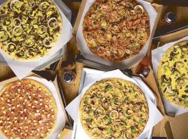  ??  ?? Start spreading the news: These new NYC-inspired Yellow Cab pizzas have been waiting for you.