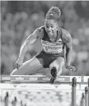  ?? Ben Stansallbe­n / AFP/Getty Images ?? American Keni Harrison clears the final hurdle on her way to a world record time of 12.20.