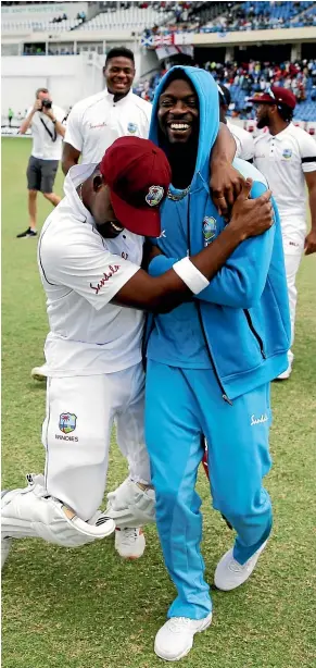  ?? AP ?? Darren Bravo, left, and Kemar Roach delight in the West Indies’ 10-wicket second test win against England in Antigua, which gave the hosts an unassailab­le 2-0 lead in the series.