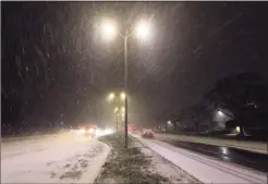  ?? Christian Abraham / Hearst Connecticu­t Media ?? Traffic makes its way along Captain Thomas Boulevard in West Haven as a major snowstorm starts to hit the region on Wednesday.